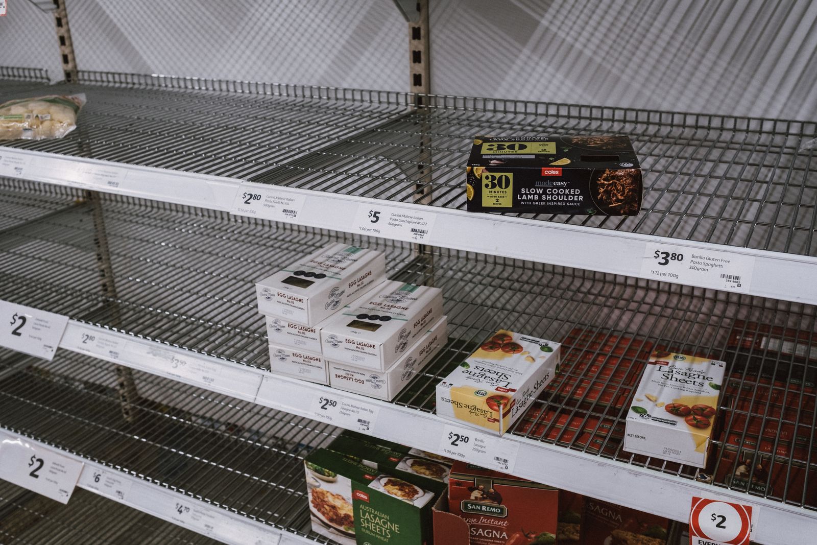 Sparsely stocked supermarket shelves in a grocery store