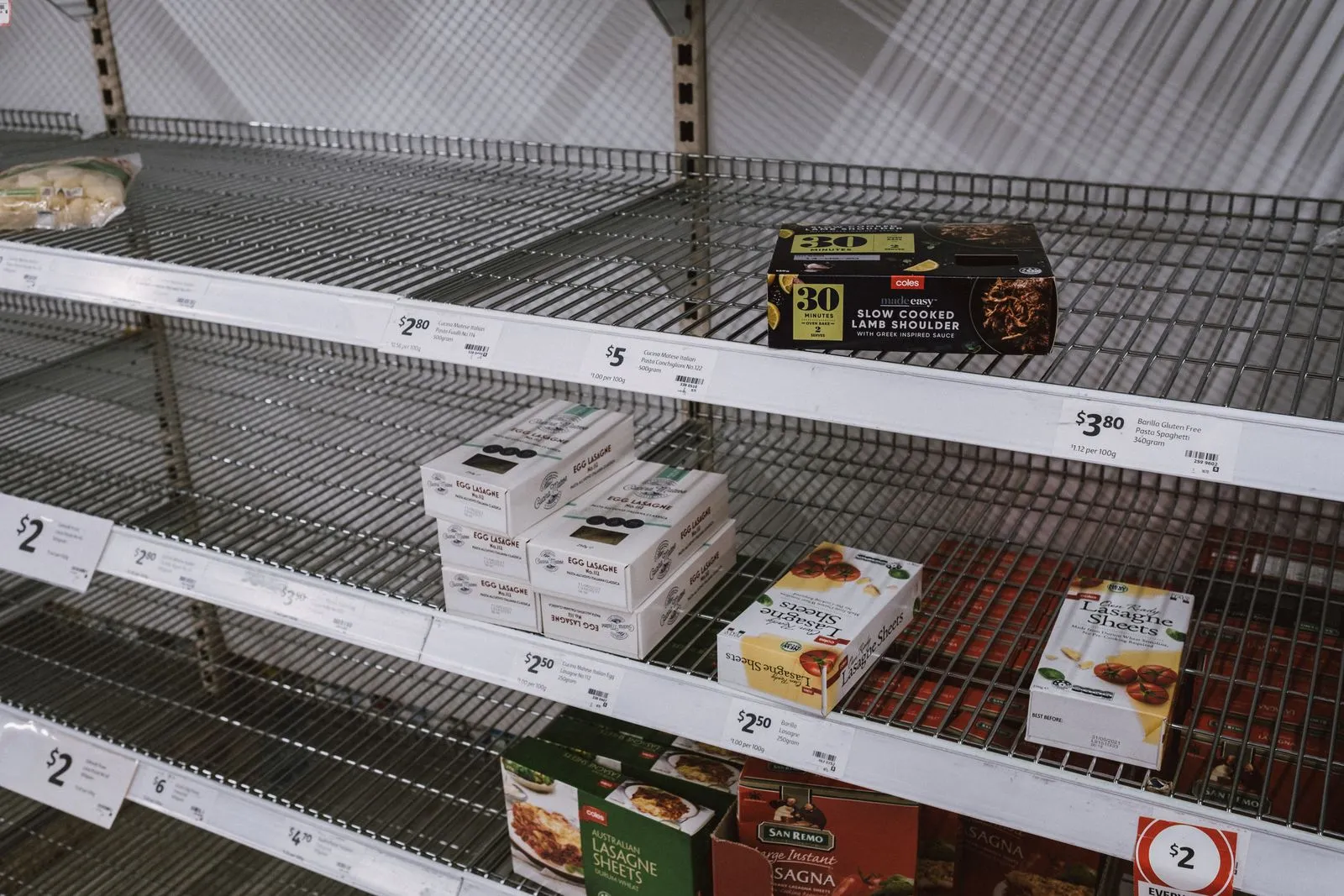 Sparsely stocked supermarket shelves in a grocery store
